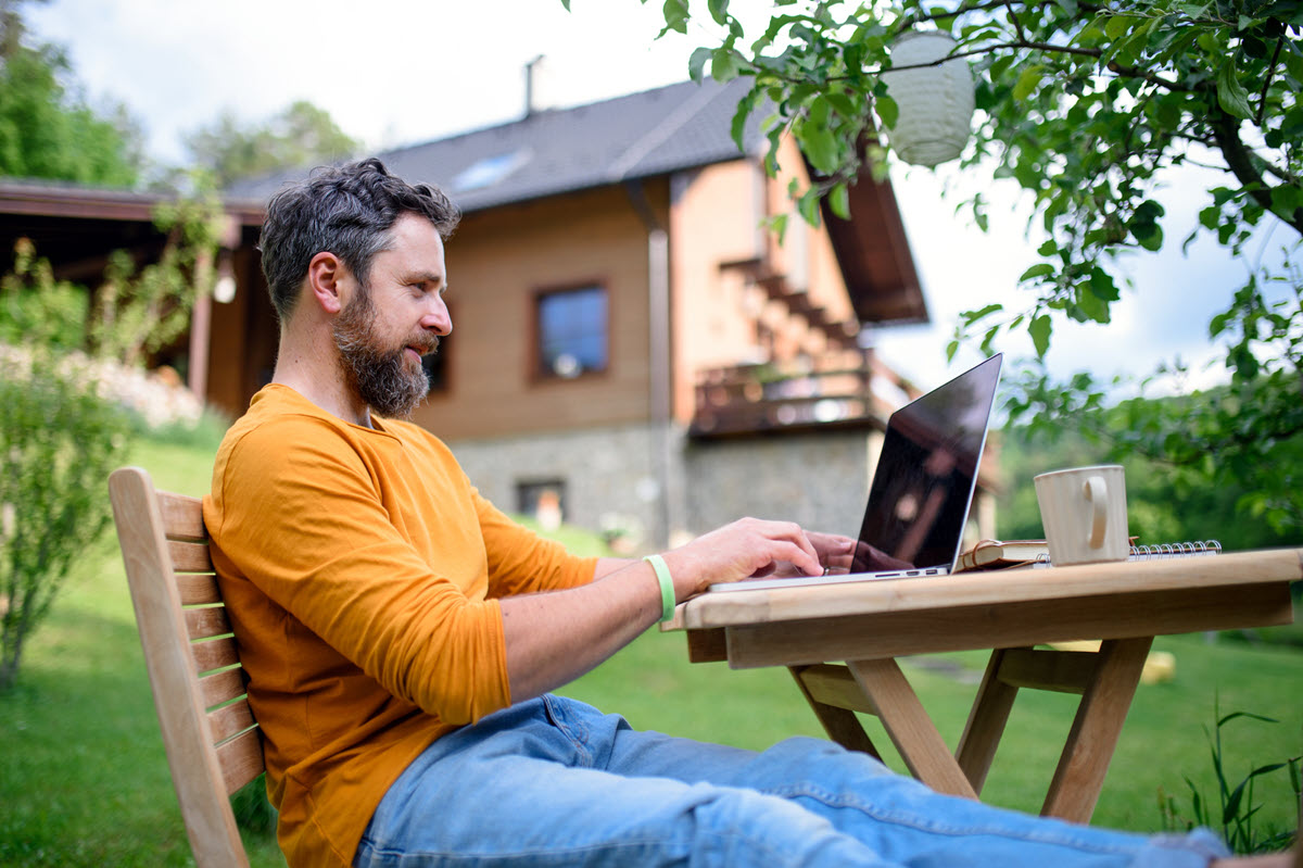 Man working outside on laptop